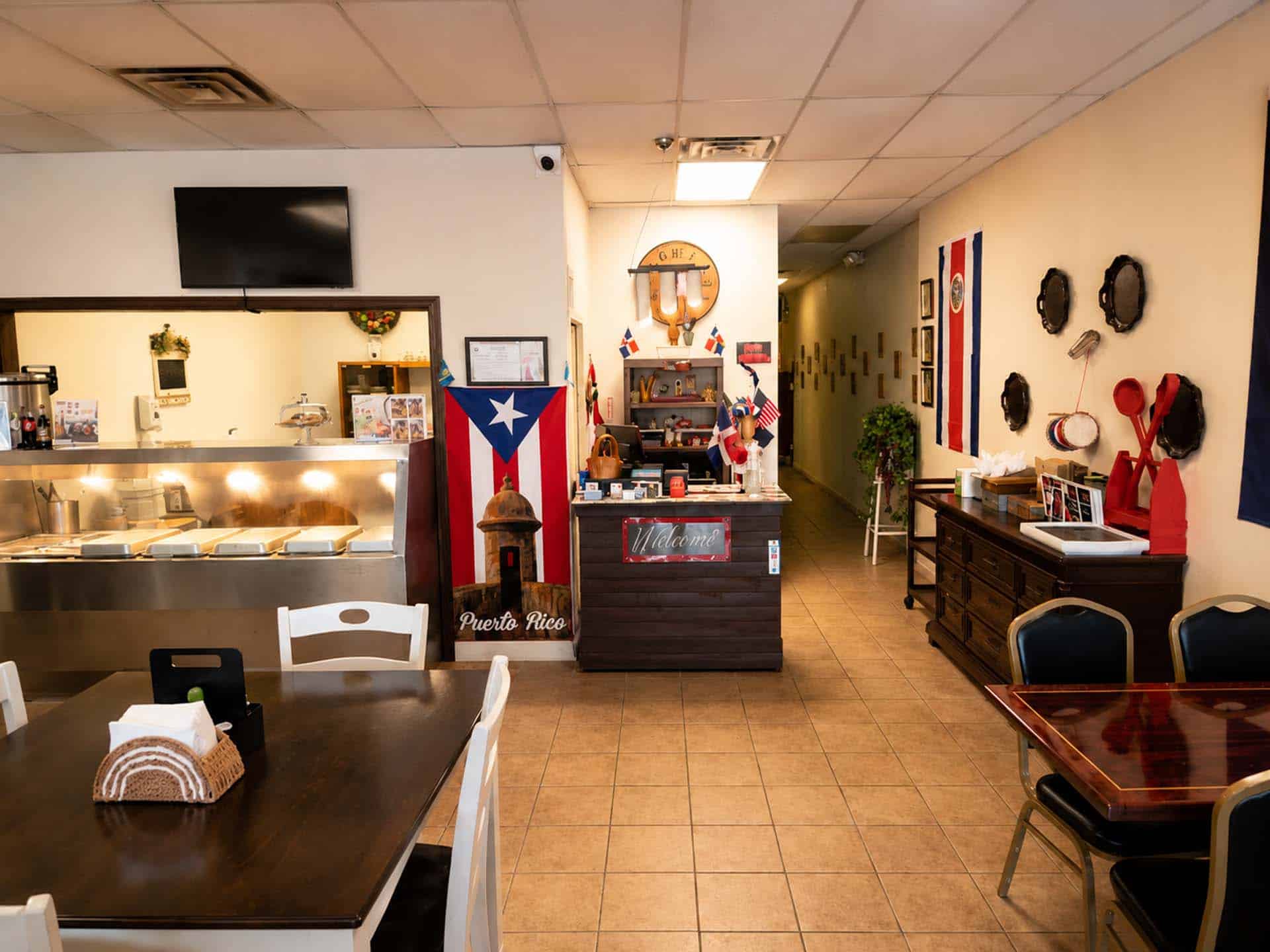 Inside Mezcla Latina Restaurant dining room decorated with Latin American flags